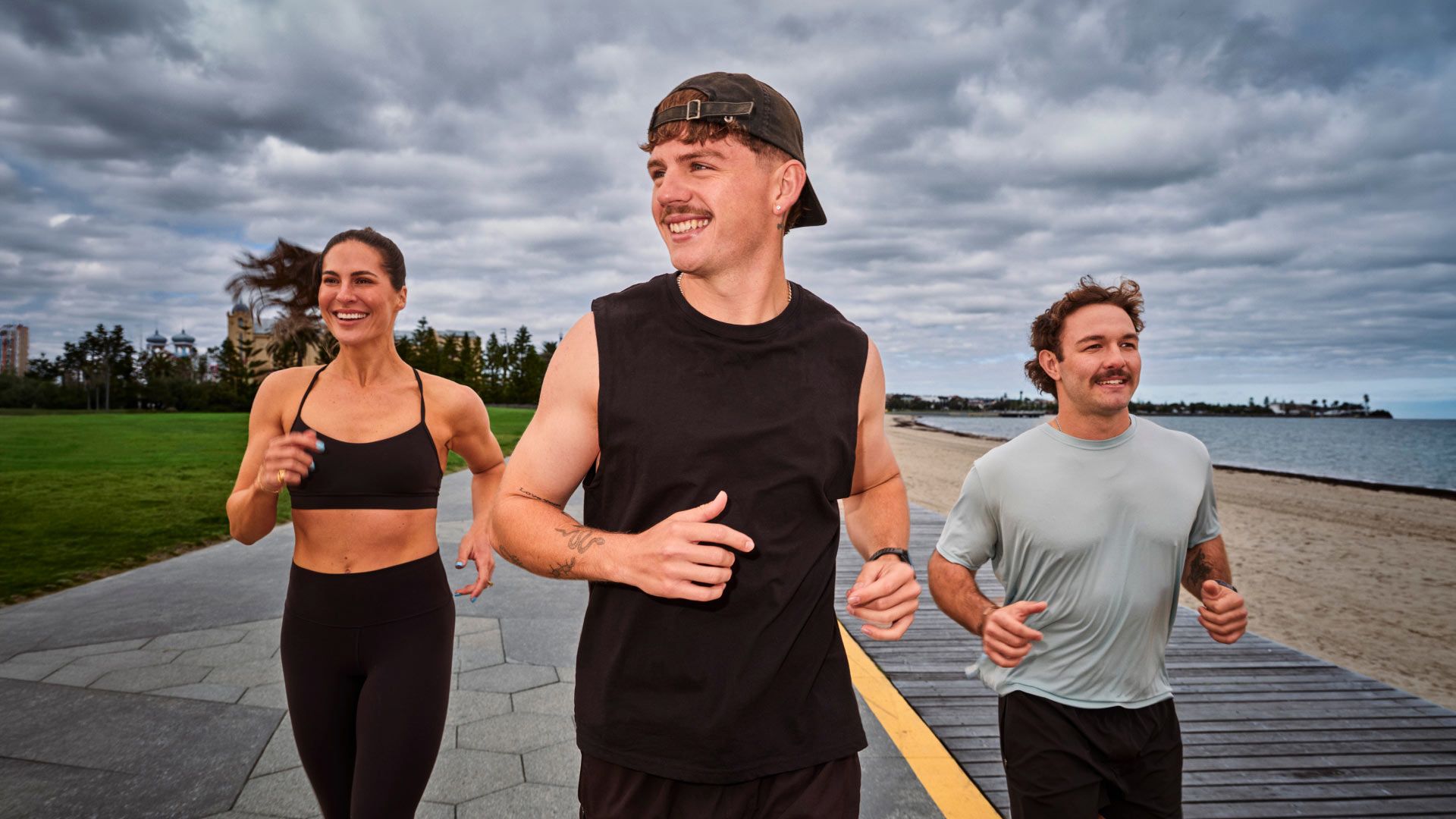 Photo of three people running on the foreshore.